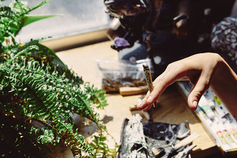 Artist Smoking Marijuana Vape Pen and Joint in Studio