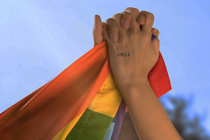 hands of two girls holding each other with the word love in the